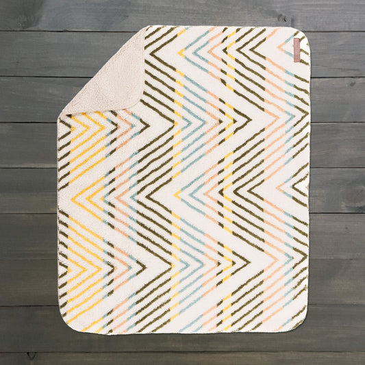 Sherpa Fleece Waterproof Blanket with yellow, pink, and blue chevron pattern, beige underside.