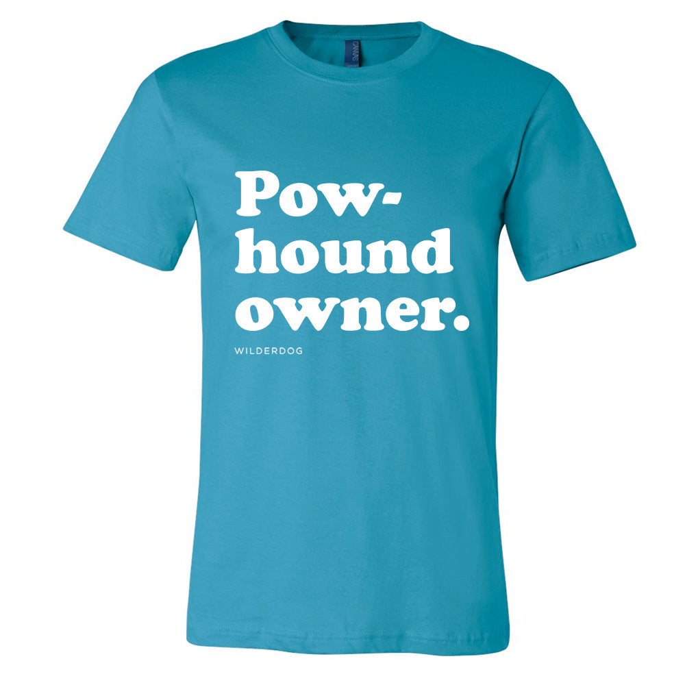 Introducing the Party Dog Tee Shirt: A teal t-shirt featuring the bold, white text "Pow-hound owner." across the front, with "WILDERDOG" printed in smaller white text beneath. This sustainably produced unisex shirt boasts short sleeves and a round neckline, making it an ideal choice for those who love vibrant colors and eco-friendly fashion.